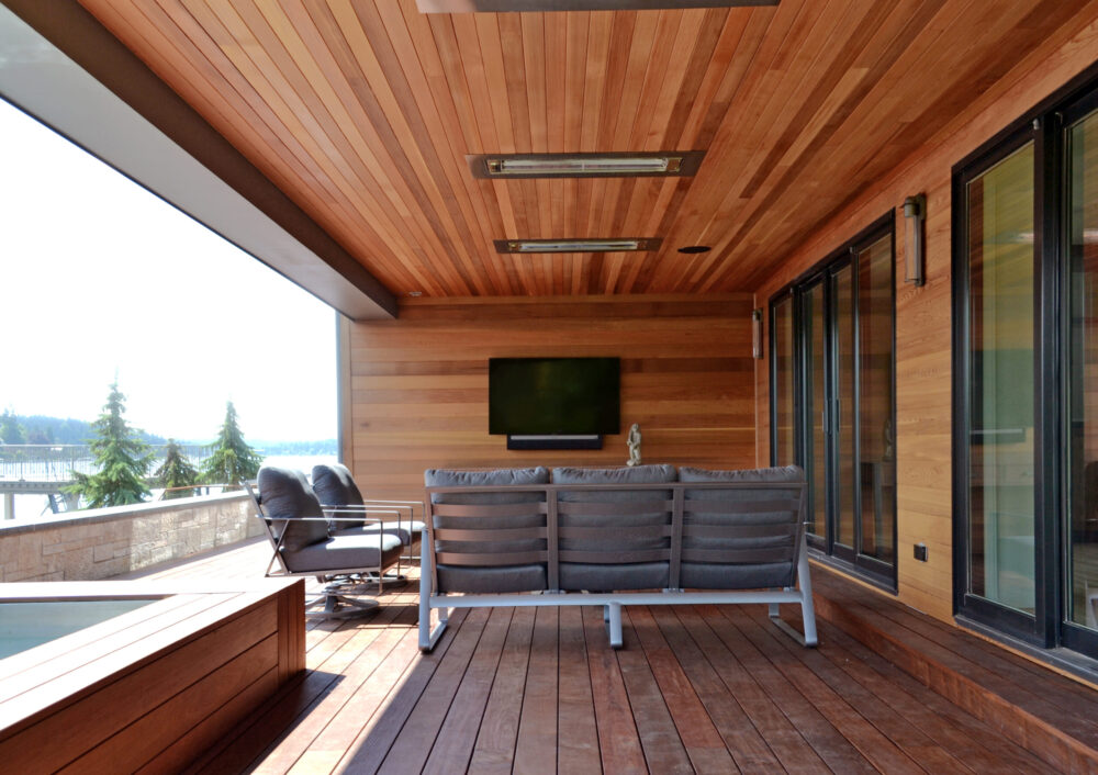 The covered patio with wood decking, siding and soffit.