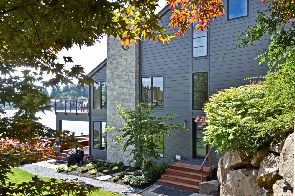 The north side of the house with a stone chimney and the side entrance.