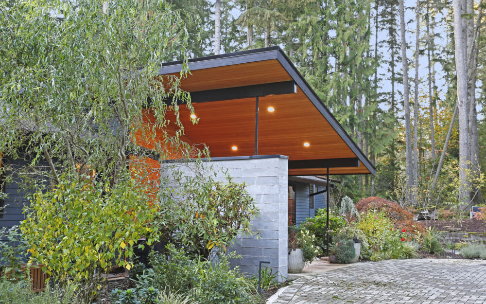 Close up view of the entry porch roof and board formed concrete wall.