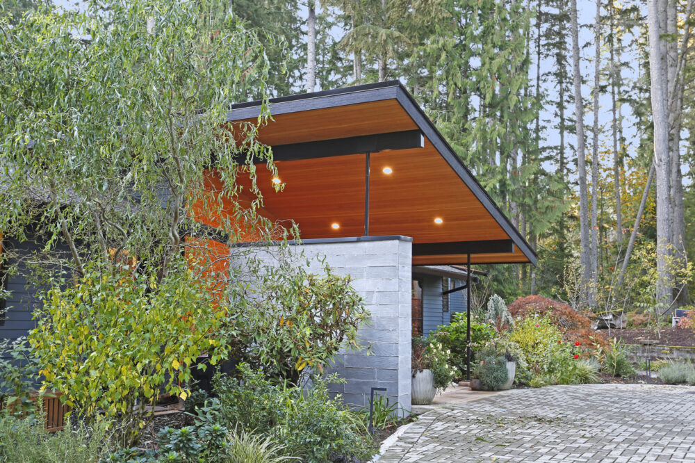 Close up view of the entry porch roof and board formed concrete wall.